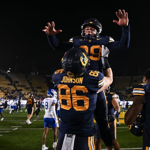 California tight end Jeffrey Johnson (86) lifts outside linebacker Michael Cooley after defeating SMU in a NCAA college football game, Saturday, Nov. 29, 2025, in Berkeley, Calif. (AP Photo/Justine Willard)