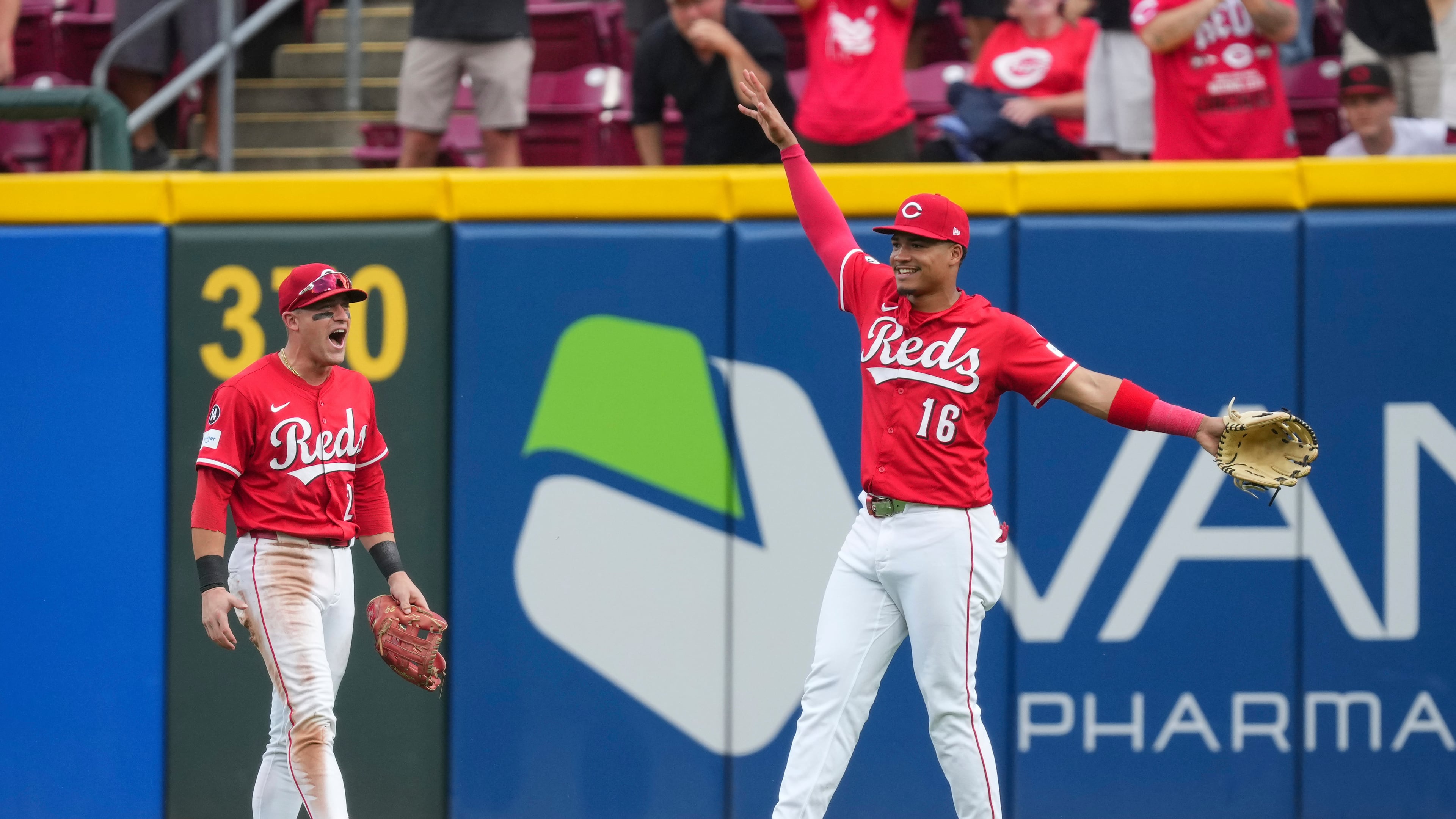 Cincinnati Reds outfielder Noelvi Marte (16) celebrates with teammate TJ Friedl (29) after catching a fly ball hit by Pittsburgh Pirates' Bryan Reynolds during the ninth inning of a baseball game, Thursday, Sept. 25, 2025, in Cincinnati. (AP Photo/Jeff Dean)