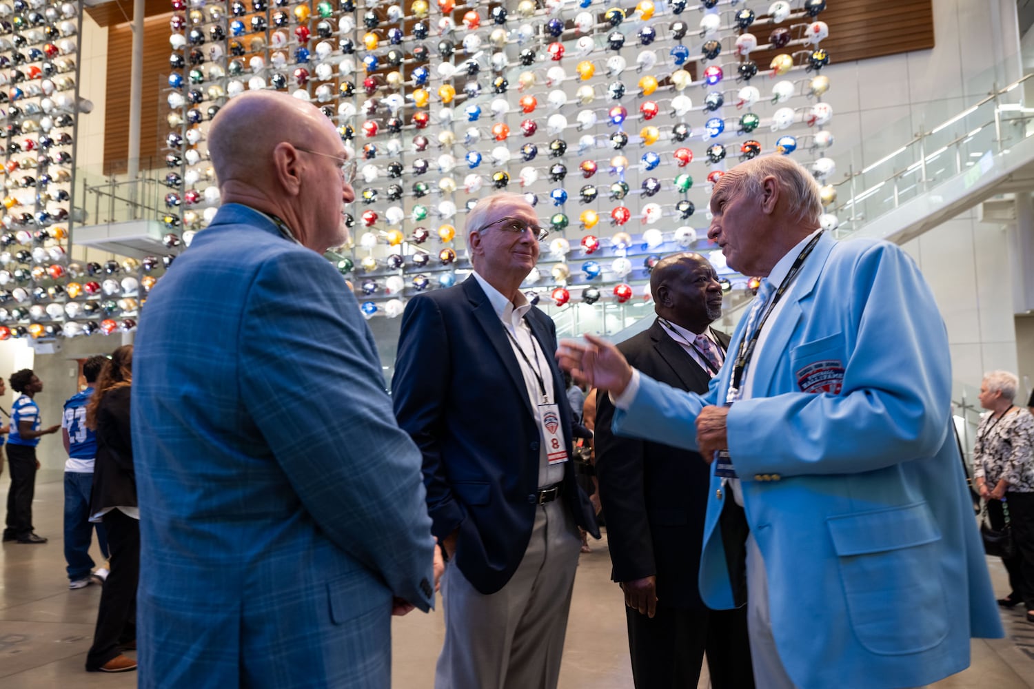 Kent Gentry (from left), David Carpenter, and Lynn Hunnicutt, all members of the 1976 Warner Robins championship football team, talk prior to the start of the Georgia High School Football Hall of Fame induction ceremony Saturday, Oct. 25, 2025, at the College Football Hall of Fame in Atlanta. (Daniel Varnado for the AJC)