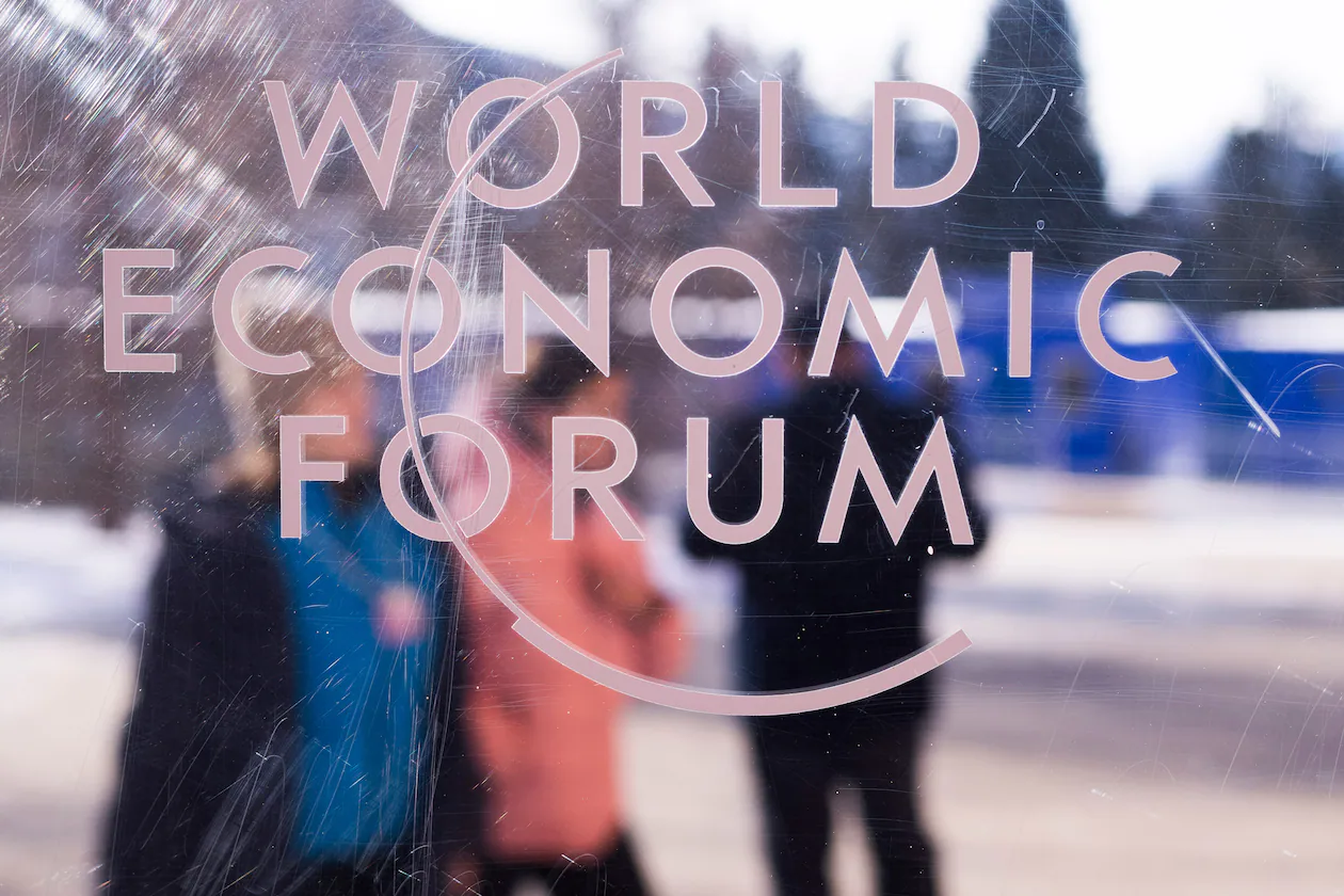The logo of the World Economic Forum is displayed on a window of the Congress Center where the Annual Meeting Forum takes place in Davos, Switzerland, on Sunday, Jan. 18, 2026. (Markus Schreiber/AP)