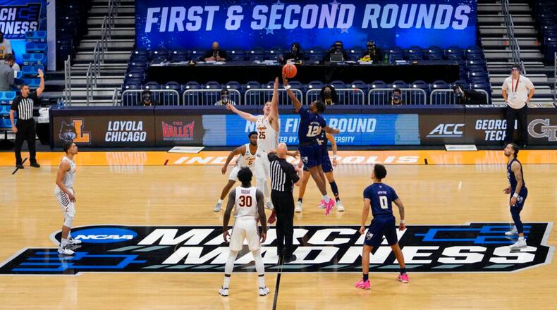 Georgia Tech tips off with Loyola Chicago at the start of a college basketball game in the first round of the NCAA tournament at Hinkle Fieldhouse, Indianapolis, Friday, March 19, 2021. (AP Photo/AJ Mast)