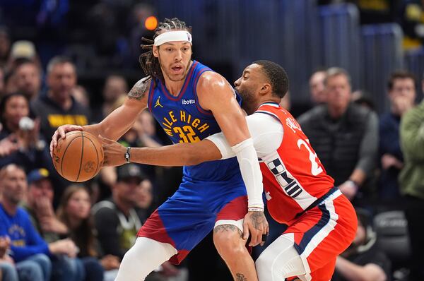 Denver Nuggets forward Aaron Gordon, left, looks to pass the ball as Los Angeles Clippers guard Norman Powell, right, defends in overtime of Game 1 of an NBA first-round playoff series Saturday, April 19, 2025, in Denver. (AP Photo/David Zalubowski)