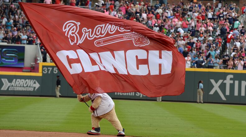 The Atlanta Braves mascot Blooper, waves a flag after the Braves clinched their division with a win over the Philadelphia Phillies at SunTrust Park on Saturday, Sept. 22, 2018.