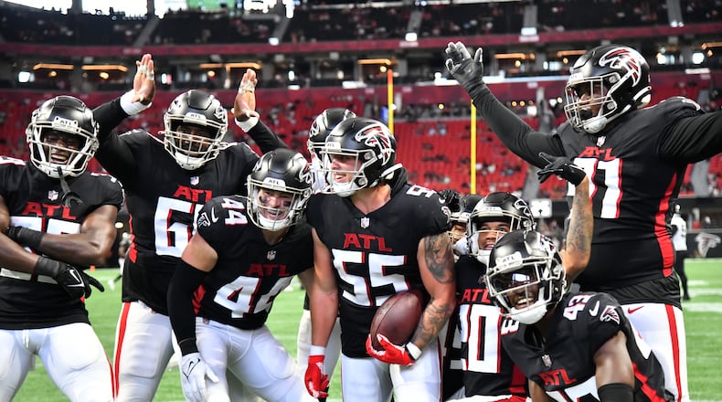 Falcons' linebacker Nathan Landman (55) celebrates with teammates after intercepting a pass during the second half of the final exhibition game of the preseason at Mercedes-Benz Stadium in Atlanta at on Saturday, August 27, 2022. Atlanta Falcons won 28-12 over Jacksonville Jaguars. (Hyosub Shin / Hyosub.Shin@ajc.com)
