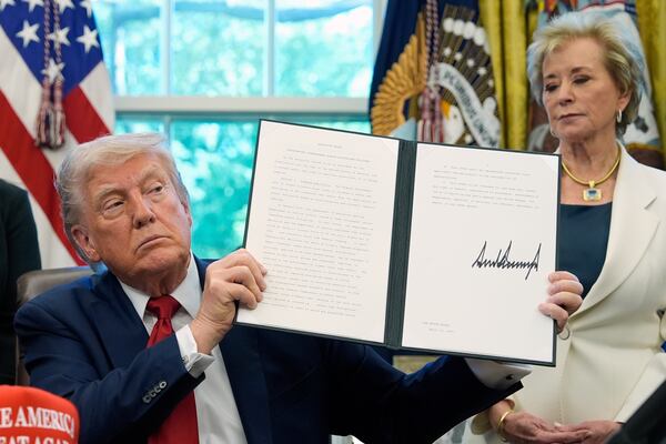 President Donald Trump holds a signed an executive order relating to school discipline policies as Education Secretary Linda McMahon listens in the Oval Office of the White House, Wednesday, April 23, 2025, in Washington. (AP Photo/Alex Brandon)