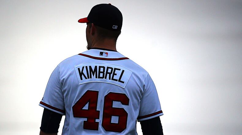 Braves closer Craig Kimbrel walks across the stadium field toward a giant light box to film a TV spot before team practice begins at sunrise Friday, Feb. 21, 2014, in Lake Buena Vista, Fla.