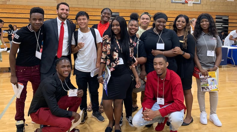 Sam Aleinikoff (second from left standing), who was a Towers High School math teacher, founded College Aim in 2013 to help DeKalb high school students navigate the college application process.  (Courtesy photo)