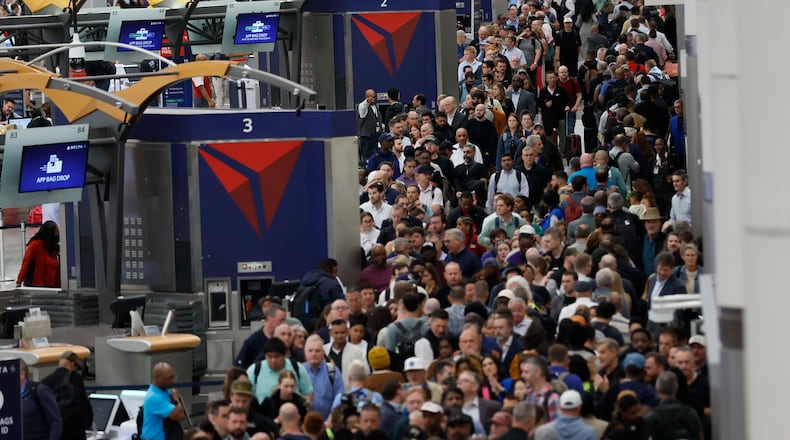 Travelers line up at the South Terminal for TSA security checks early Monday morning at Hartsfield-Jackson Atlanta International Airport during the partial government shutdown on March 23, 2026. TSA officers have been working without pay for weeks amid the shutdown. (Miguel Martinez/AJC)