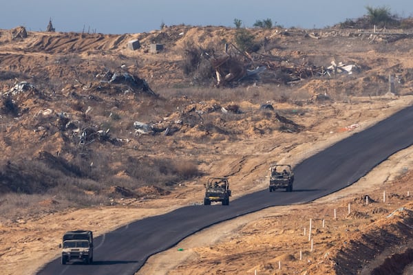 FILE - Israeli military vehicles move inside the Gaza Strip, as seen from southern Israel, Tuesday, Jan. 7, 2025. (AP Photo/Ariel Schalit, File)