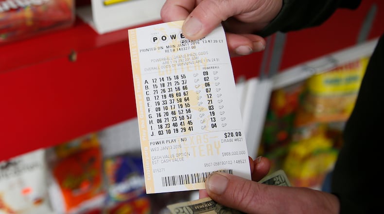 Jeff Johnson shows off his 10 ticket after buying it from the Zip-N Store in north Austin on Monday, afternoon. Jan. 11, 2016. RICARDO B. BRAZZIELL/AMERICAN-STATESMAN