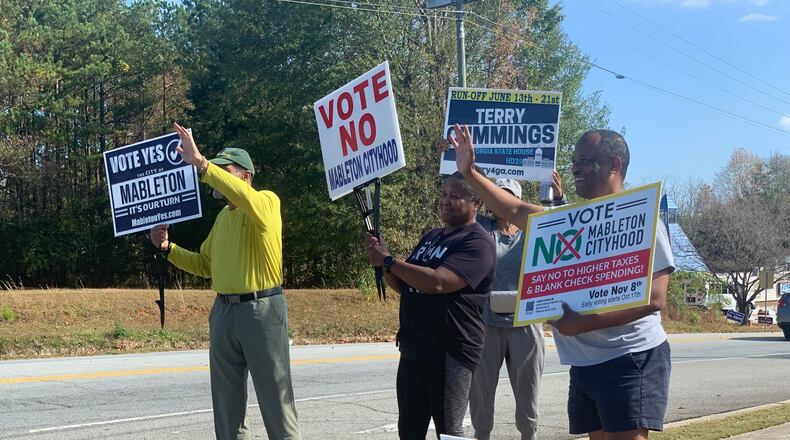 Supporters and opponents of the Mableton cityhood movement rally near a polling precinct Tuesday.