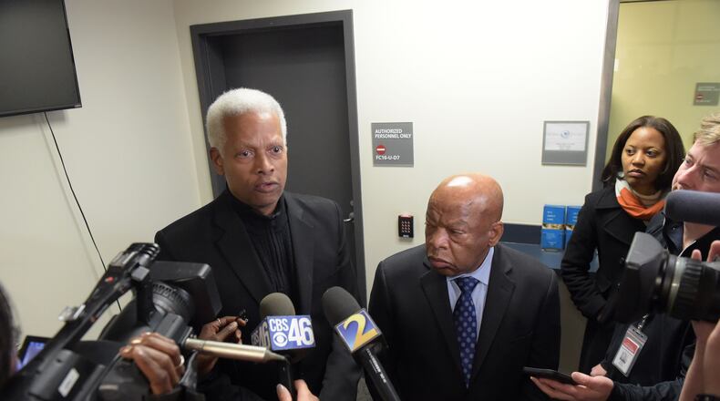 Democratic U. S. Congressmen Hank Johnson, left, and John Lewis talk with the media following a meeting inside the Customs and Border Protection office at Hartsfield Jackson International airport on Jan. 25, 2017. Kent D. Johnson/AJC