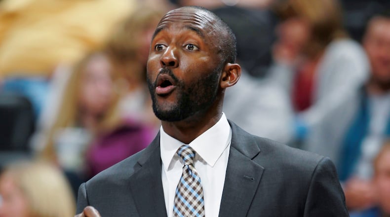 Philadelphia 76ers assistant coach Lloyd Pierce directs players against the Denver Nuggets in the third quarter of the Sixers' 114-102 victory in an NBA basketball game in Denver on Wednesday, Jan. 1, 2014. (AP Photo/David Zalubowski)