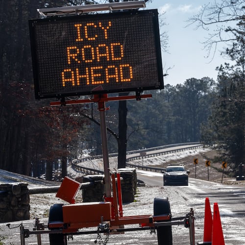 A sign warns travelers of icy roads on Buford Dam Road in Cumming on Monday, Jan. 26, 2026. Temperatures will remain frigid to start Tuesday. (Ben Hendren for the AJC)
