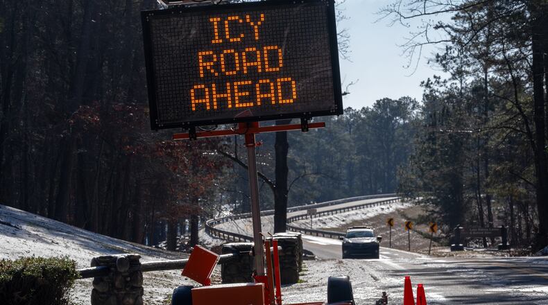 A sign warns travelers of icy roads on Buford Dam Road in Cumming on Monday, Jan. 26, 2026. Temperatures will remain frigid to start Tuesday. (Ben Hendren for the AJC)
