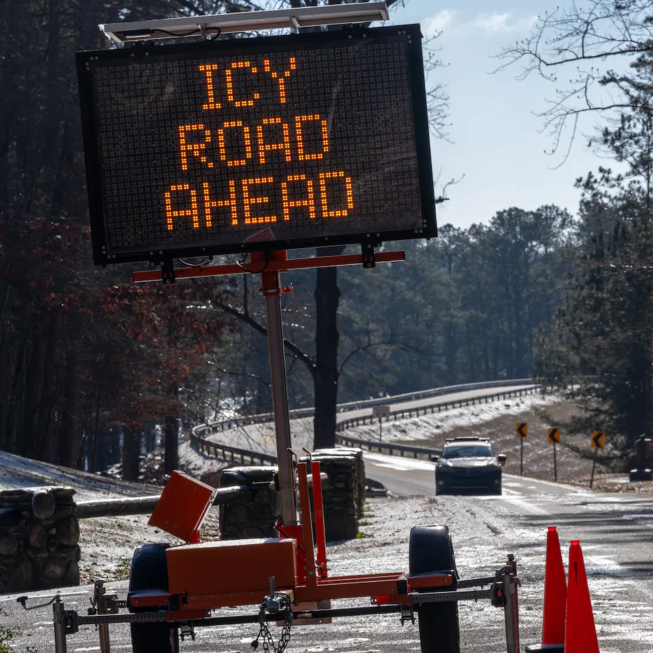 A sign warns travelers of icy roads on Buford Dam Road in Cumming on Monday, Jan. 26, 2026. Temperatures will remain frigid to start Tuesday. (Ben Hendren for the AJC)