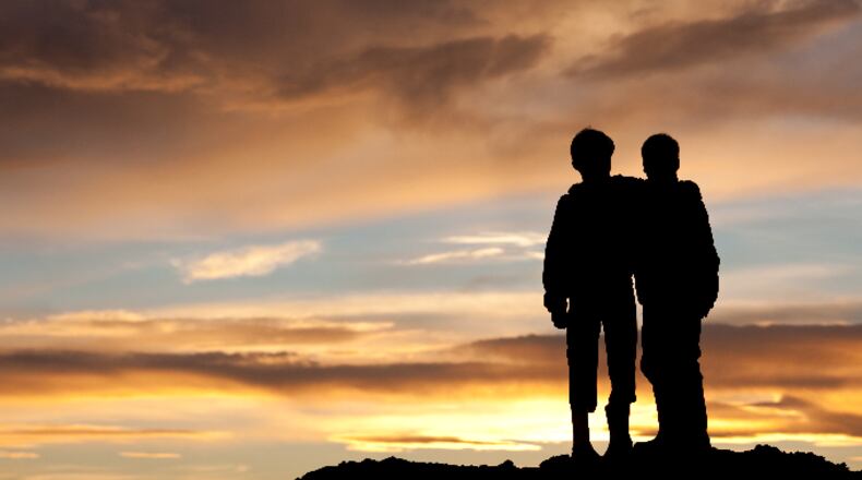 Children watching sunset (ImagineGolf / E+ / Getty Images)