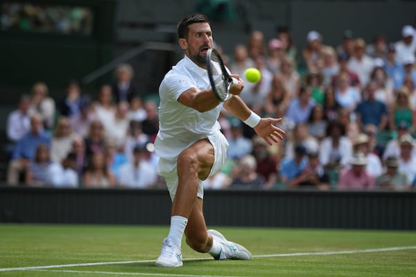 Novak Djokovic of Serbia returns to Daniel Evans of Britain during their second round men's singles match at the Wimbledon Tennis Championships in London, Thursday, July 3, 2025. (AP Photo/Alastair Grant)