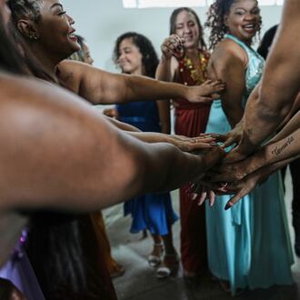 Inmates wish each other good luck before competing in the Voice of Freedom rehabilitation program singing contest at the Djanira Dolores de Oliveira women's penitentiary in Rio de Janeiro, Friday, Jan. 23, 2026. (AP Photo/Silvia Izquierdo)