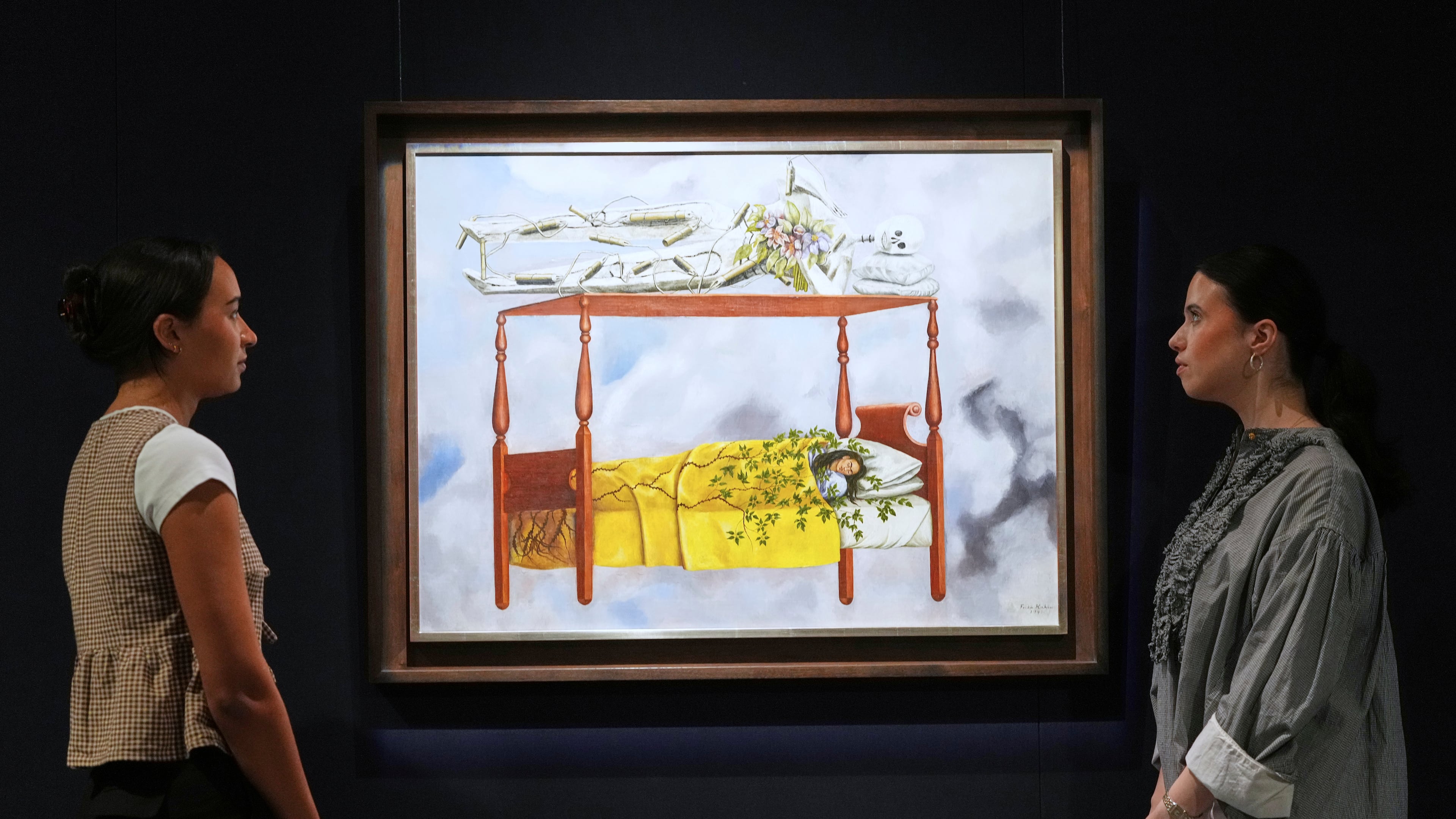 A painting by Frida Kahlo called El sueño (La cama) is displayed at Sotheby's auction rooms, the painting estimated at 40-60 million US dollars is part of a collection of surrealist masterpieces unveiled in London ahead of their sale in New York, Friday, Sept. 19, 2025. (AP Photo/Kirsty Wigglesworth)