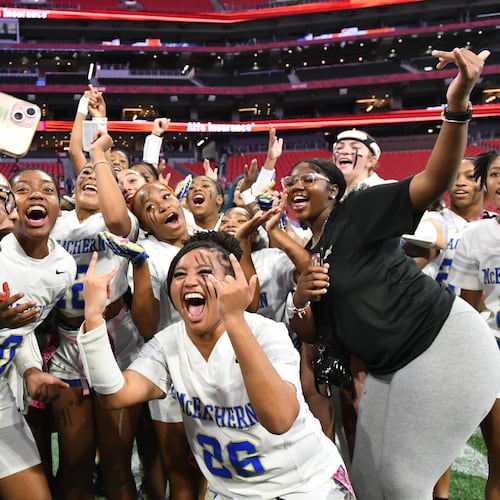 McEachern players celebrate their victory over Lambert in GHSA Division 4 Flag Football State Championship game at Mercedes-Benz Stadium, Wednesday, Dec. 18, 2024, in Atlanta. McEachern won 26-6 over Lambert. (Hyosub Shin/AJC)