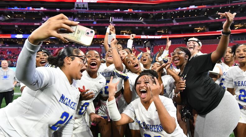 McEachern players celebrate their victory over Lambert in GHSA Division 4 Flag Football State Championship game at Mercedes-Benz Stadium, Wednesday, December 18, 2024, in Atlanta. McEachern won 26-6 over Lambert. (Hyosub Shin / AJC)