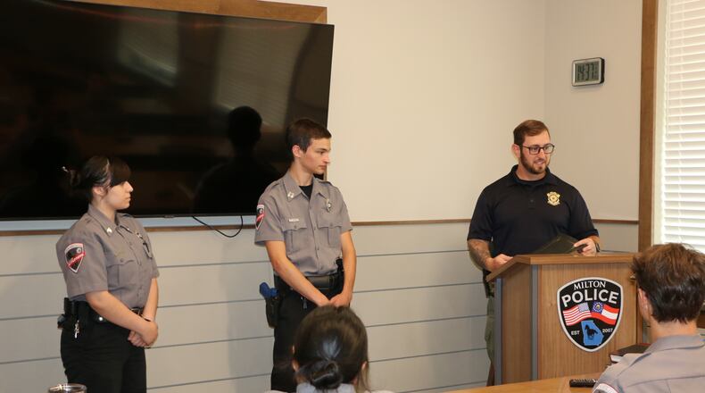 Chad West (at podium), community outreach officer with the Milton Police, speaks with participants in the department's student Explorers program.