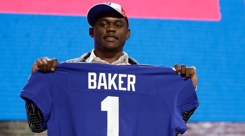 Georgia defensive back DeAndre Baker poses with his new jersey after the New York Giants selected him in the first round at the NFL football draft April 25, 2019, in Nashville, Tenn.