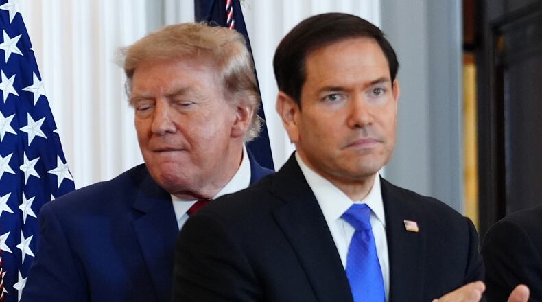 President Donald Trump walks past Secretary of State Marco Rubio as he arrives for a roundtable on the American mining industry, Friday, Aug. 7, 2026, at the State Department in Washington. (AP Photo/Julia Demaree Nikhinson)