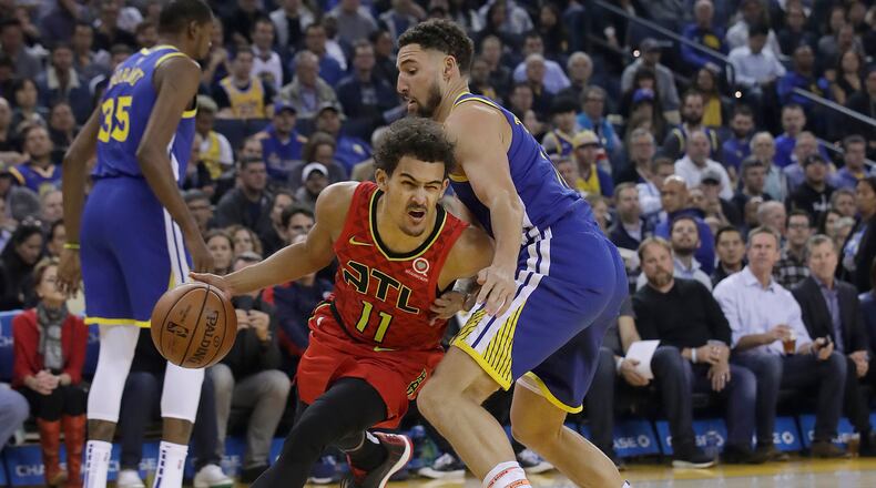 Hawks guard Trae Young, left, drives against Golden State Warriors guard Klay Thompson during the first half of an NBA basketball game in Oakland, Calif., Tuesday, Nov. 13, 2018. (AP Photo/Jeff Chiu)