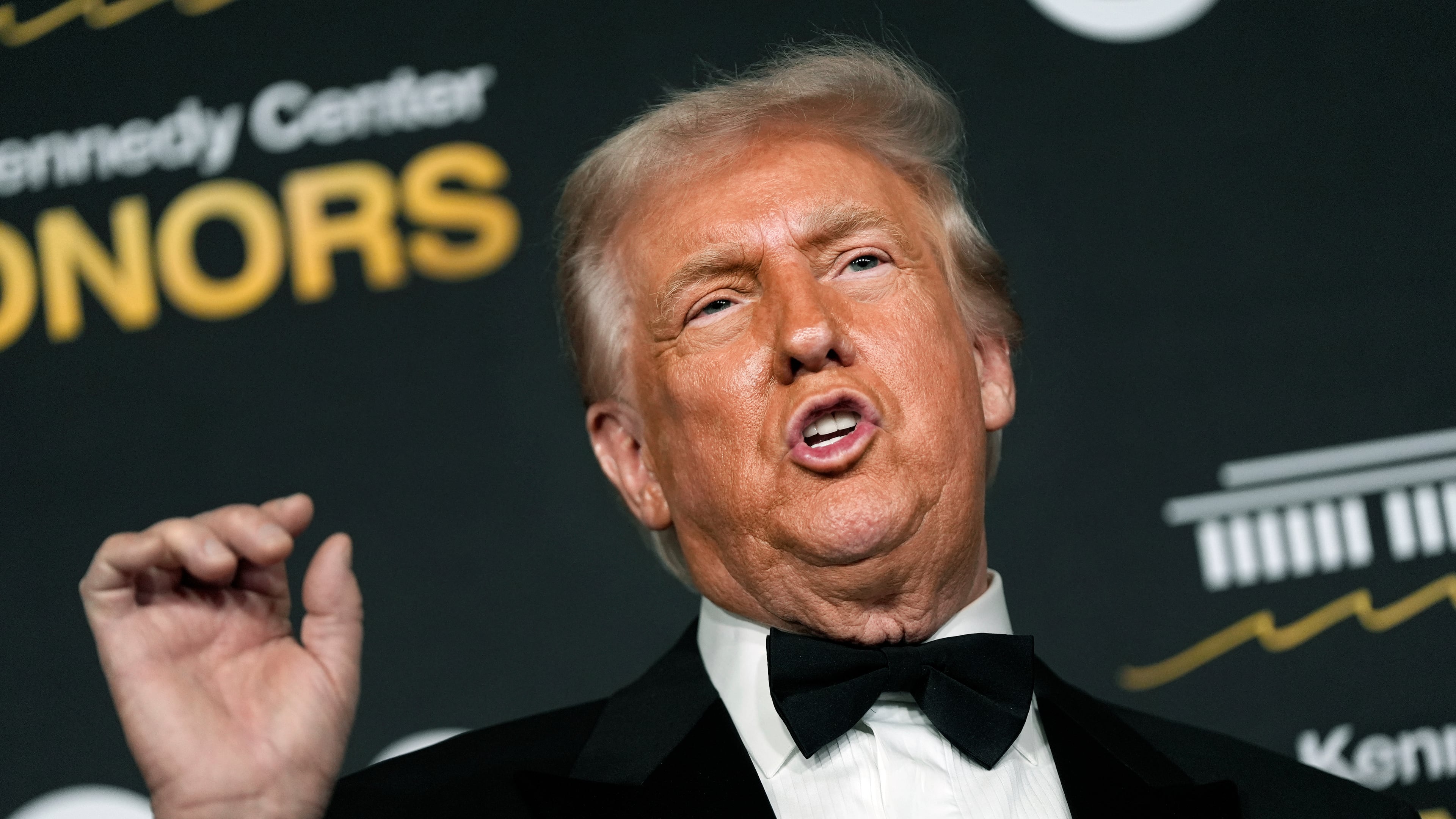 President Donald Trump talks to the media while walking the red carpet before the 48th Kennedy Center Honors, Sunday, Dec. 7, 2025, at the John F. Kennedy Center for the Performing Arts in Washington. (AP Photo/Julia Demaree Nikhinson)