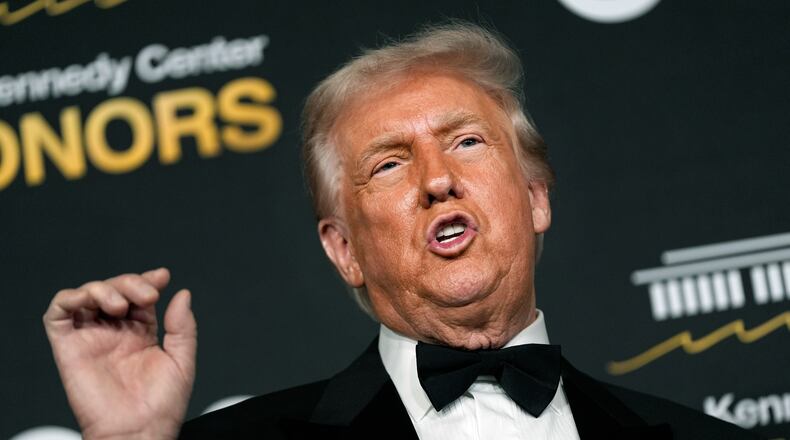 President Donald Trump talks to the media while walking the red carpet before the 48th Kennedy Center Honors, Sunday, Dec. 7, 2025, at the John F. Kennedy Center for the Performing Arts in Washington. (AP Photo/Julia Demaree Nikhinson)