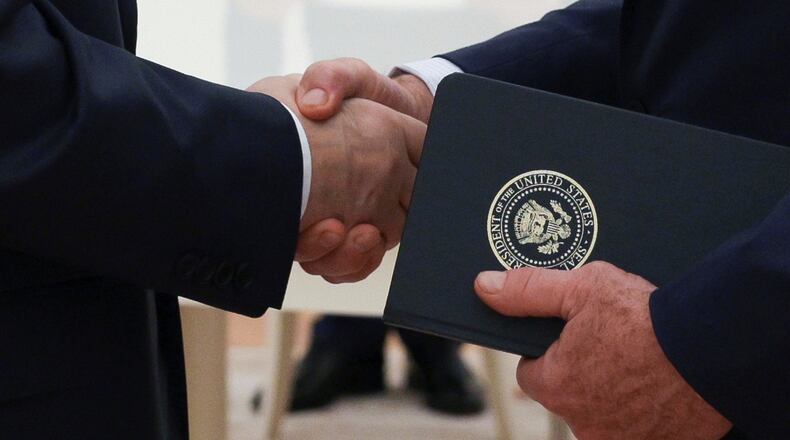 FILE - Russian President Vladimir Putin and U.S. President Donald Trump's special envoy Steve Witkoff shakes hands during their meeting at the Kremlin, in Moscow, on Aug. 6, 2025. (Gavriil Grigorov, Sputnik, Kremlin Pool Photo via AP, File)