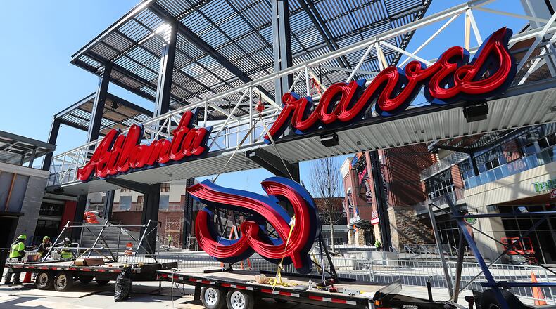 File Photo: Construction workers prepare to install the B on a Braves sign across a pedestrian bridge into SunTrust Park. (Curtis Compton/ccompton@ajc.com)