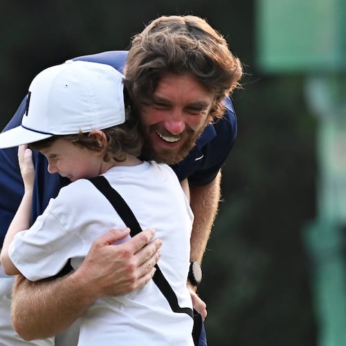 Tommy Fleetwood of England hugs his son Frankie after wining the DP World Tour Championship golf tournament in New Delhi, India, Sunday, Oct.19, 2025. (AP Photo/Dharam Diwakar)