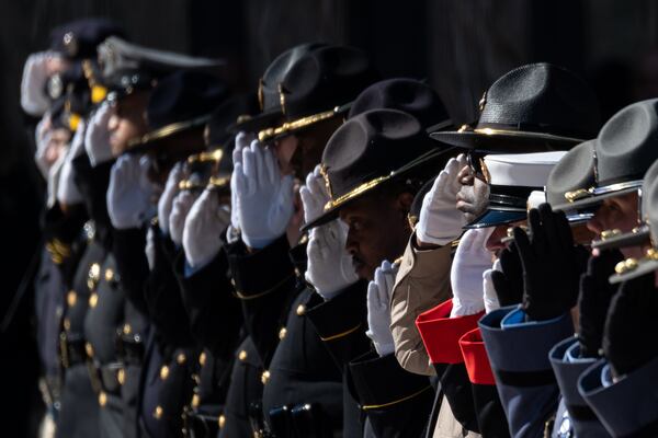 A law enforcement honor guard salutes as the remains of Gwinnett County police officer Pradeep Tamang depart following a celebration of life ceremony at 12Stone Church on Saturday, Feb. 7, 2026, in Lawrenceville. (Ben Gray for the AJC)
