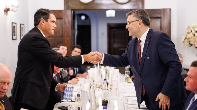 Then-Lt. Gov. Geoff Duncan, left, shakes hands with Florian Herrmann, a member of the Bavarian State Parliament, during a trip to Germany. The price tag for the 14-member delegation Duncan led to Europe shortly before leaving office has now reached about $110.000.