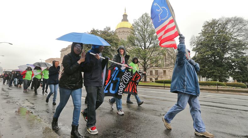 Carol Jones an advocacy specialist from the Shepherd Center carries a disability flag as she joined disability advocates and supporters who gathered in the rain at Liberty Plaza for the 17th Annual Disability Day for a State of Georgia Capitol rally hosted by the Georgia Council on Developmental Disabilities (GCDD) on Thursday, March 5, 2015. Advocates from across the state join together for support of legislation that will promote the independence, inclusion, productivity and self-determination of people with disabilities.