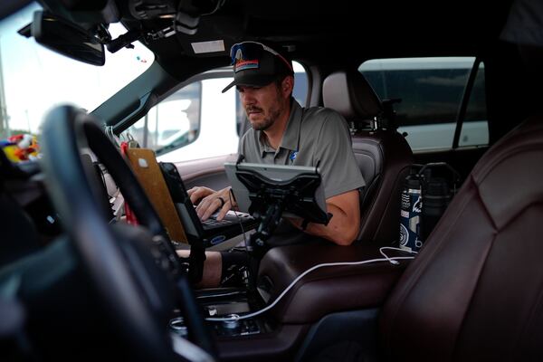 Victor Gensini, Northern Illinois University meteorology professor and a lead scientist of Project ICECHIP, works on a laptop in the command vehicle as members of Project ICECHIP stage at a Valero gas station Thursday, June 5, 2025, in Brownfield, Texas. (AP Photo/Carolyn Kaster)