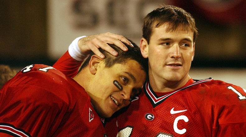 Georgia quarterback David Greene (right) gives David Pollack, longtime friends before arriving together at UGA, a hug after they played their last home at Sanford Stadium on Saturday, November 27, 2004. (JOHNNY CRAWFORD/AJC staff)