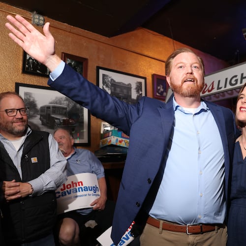 State Sen. John Cavanaugh, candidate for the Democratic nomination to the House of Representatives in Nebraska's second district, left, stands with his wife, Kakie McGill, during an election night watch party Tuesday, May 12, 2026, in Omaha, Neb. (AP Photo/Rebecca S. Gratz)