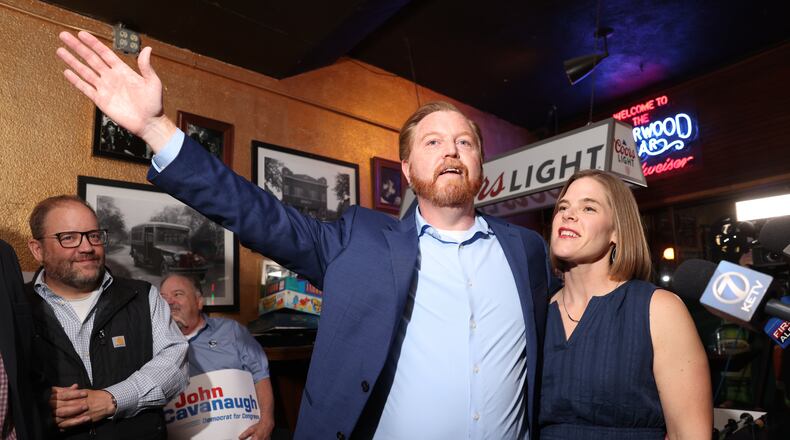 State Sen. John Cavanaugh, candidate for the Democratic nomination to the House of Representatives in Nebraska's second district, left, stands with his wife, Kakie McGill, during an election night watch party Tuesday, May 12, 2026, in Omaha, Neb. (AP Photo/Rebecca S. Gratz)