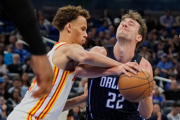 Atlanta Hawks guard Dyson Daniels, left, fouls Orlando Magic forward Franz Wagner (22) as he attempts a shot during the second half of an NBA basketball game, Tuesday, April 8, 2025, in Orlando, Fla. (AP Photo/John Raoux)