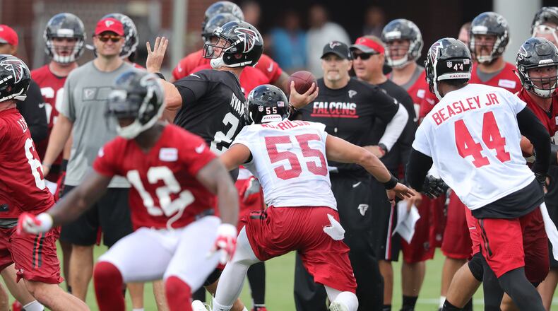 Falcons head coach Dan Quinn (background) knows he needs to get more from the pass rush this season, including Vic Beasley Jr. (right). (Curtis Compton /ccompton@ajc.com)