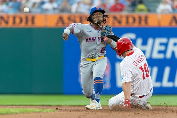 Philadelphia Phillies' Buddy Kennedy (19) is forced out at second as New York Mets second baseman Luisangel Acuna (2) throws to first in the third inning of a baseball game, Sunday, June 22, 2025, in Philadelphia. (AP Photo/Laurence Kesterson)