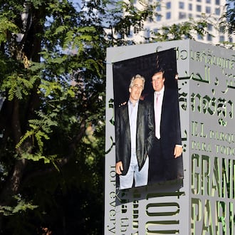 A 1997 photograph of the late Jeffrey Epstein (left) and Donald Trump was posted on a sign at Gloria Molina Grand Park in Los Angeles in June. (TNS)