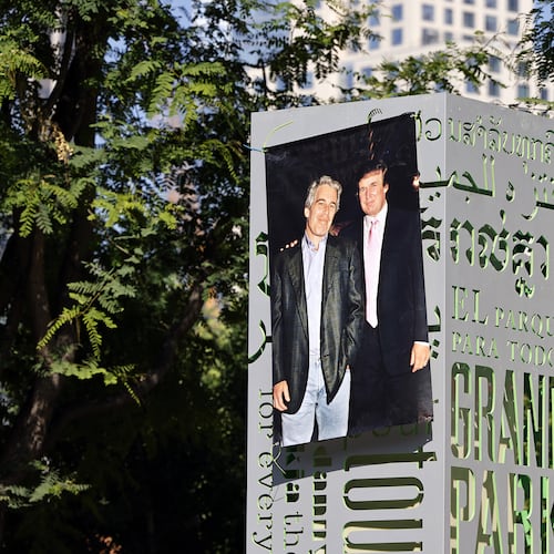 A 1997 photograph of the late Jeffrey Epstein (left) and Donald Trump was posted on a sign at Gloria Molina Grand Park in Los Angeles in June. (TNS)
