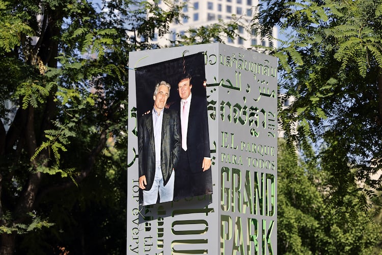 A 1997 photograph of the late Jeffrey Epstein (left) and Donald Trump was posted on a sign at Gloria Molina Grand Park in Los Angeles in June. (TNS)