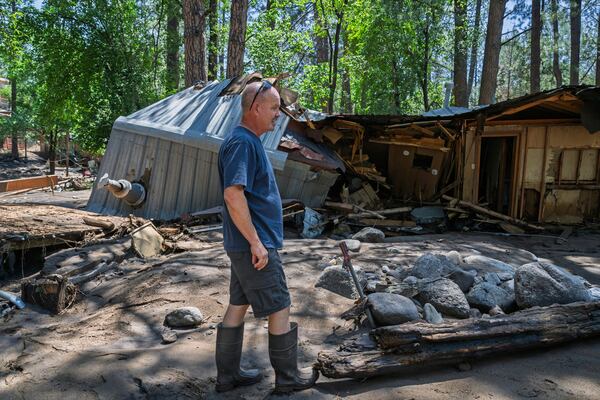 Dan Privett stands on what would be the front of his house, Wednesday, July 9, 2025, in Ruidoso, N.M., which was destroyed in the flash floods yesterday that hit the town. (AP Photo/Roberto E. Rosales)