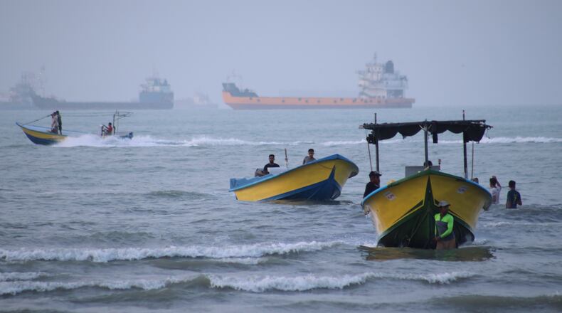 Small boats line the shore as cargo ships and other commercial vessels appear anchored in the Strait of Hormuz off Bandar Abbas, Iran, Monday, July 27, 2026. (Razieh Poudat/ISNA via AP)